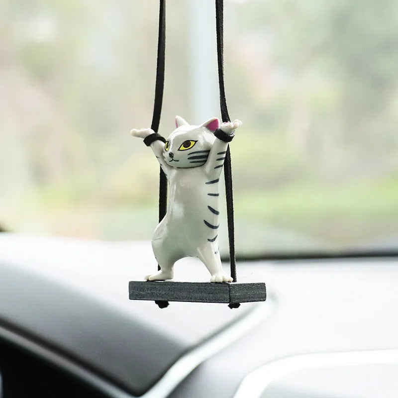 Cartoon style resin cat pendant on a rope for hanging in a car, shown in multiple colour options.