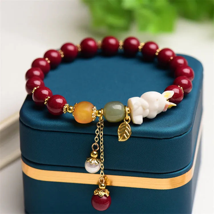 Natural beeswax purple gold sand bracelet with a detailed hand-carved cinnabar rabbit charm.