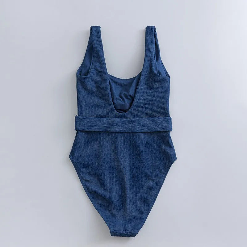 Women's navy blue solid colour one-piece swimsuit with triangle shape and chest pads on a mannequin.