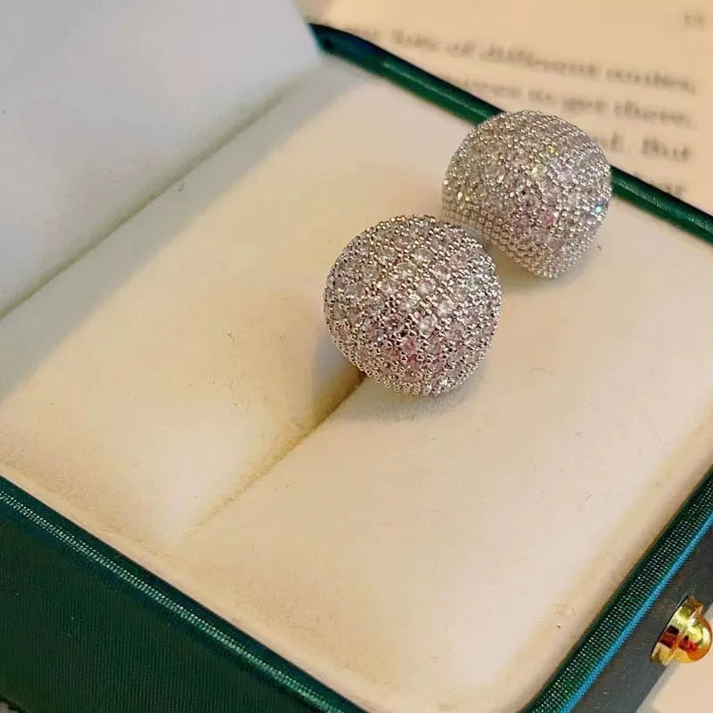 Geometric drop-shaped ear clips with full diamond detailing and sphere elements in gold and white colour options