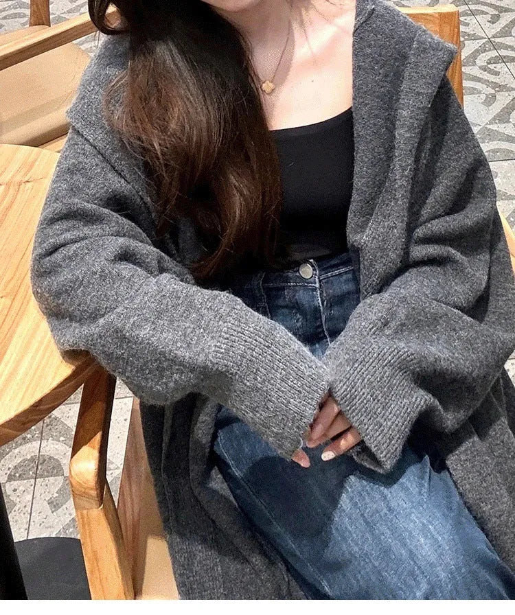 Women's long hooded cardigan in wool blend fabric showing below-the-knee length and loose fit silhouette