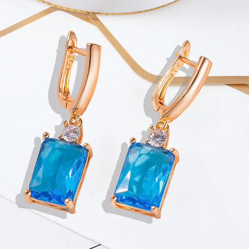 Square geometric copper earrings with gold or silver electroplated finish showing quadrilateral shape.