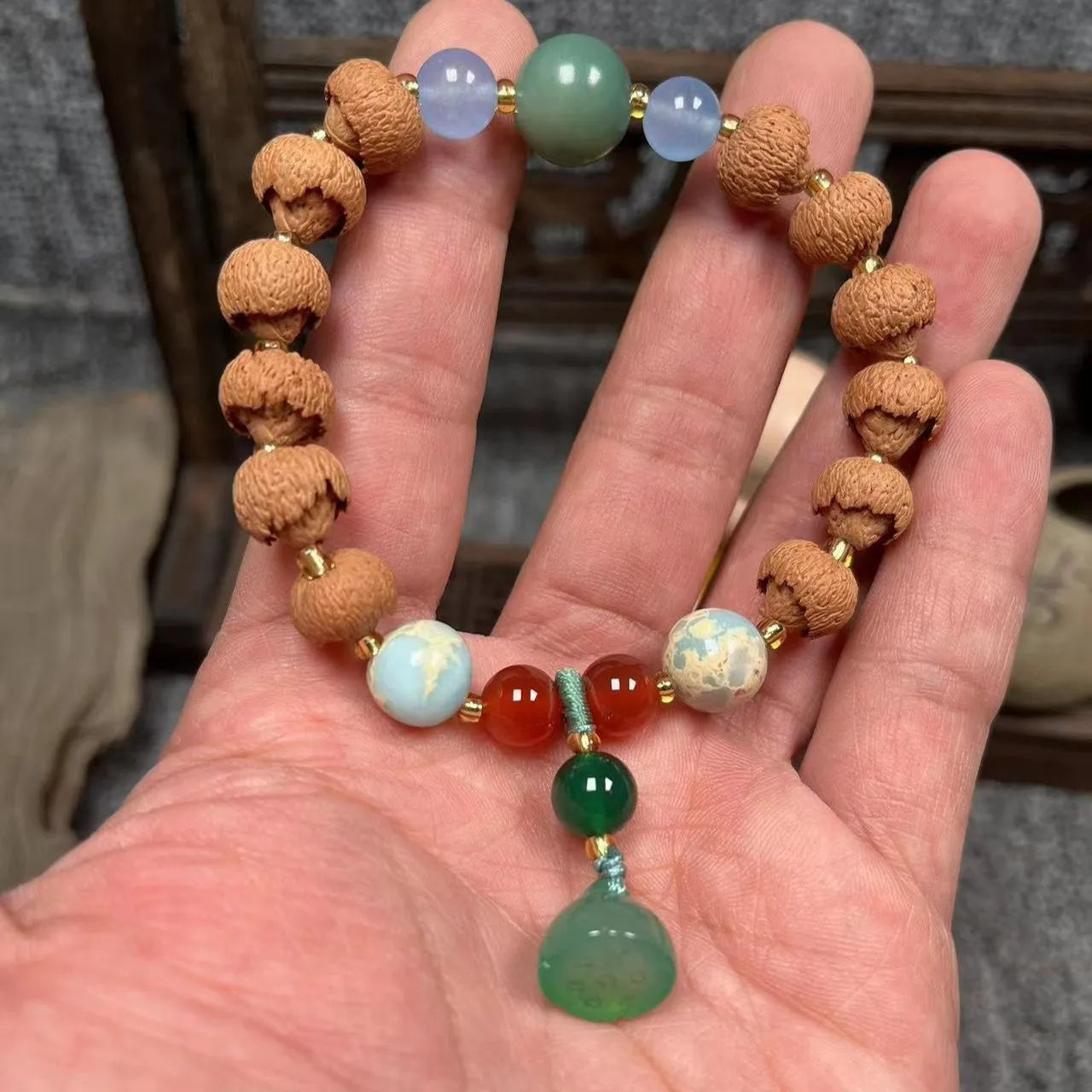 Carved pumpkin lotus bodhi root bracelet with white jade segments and golden silk jade treasures