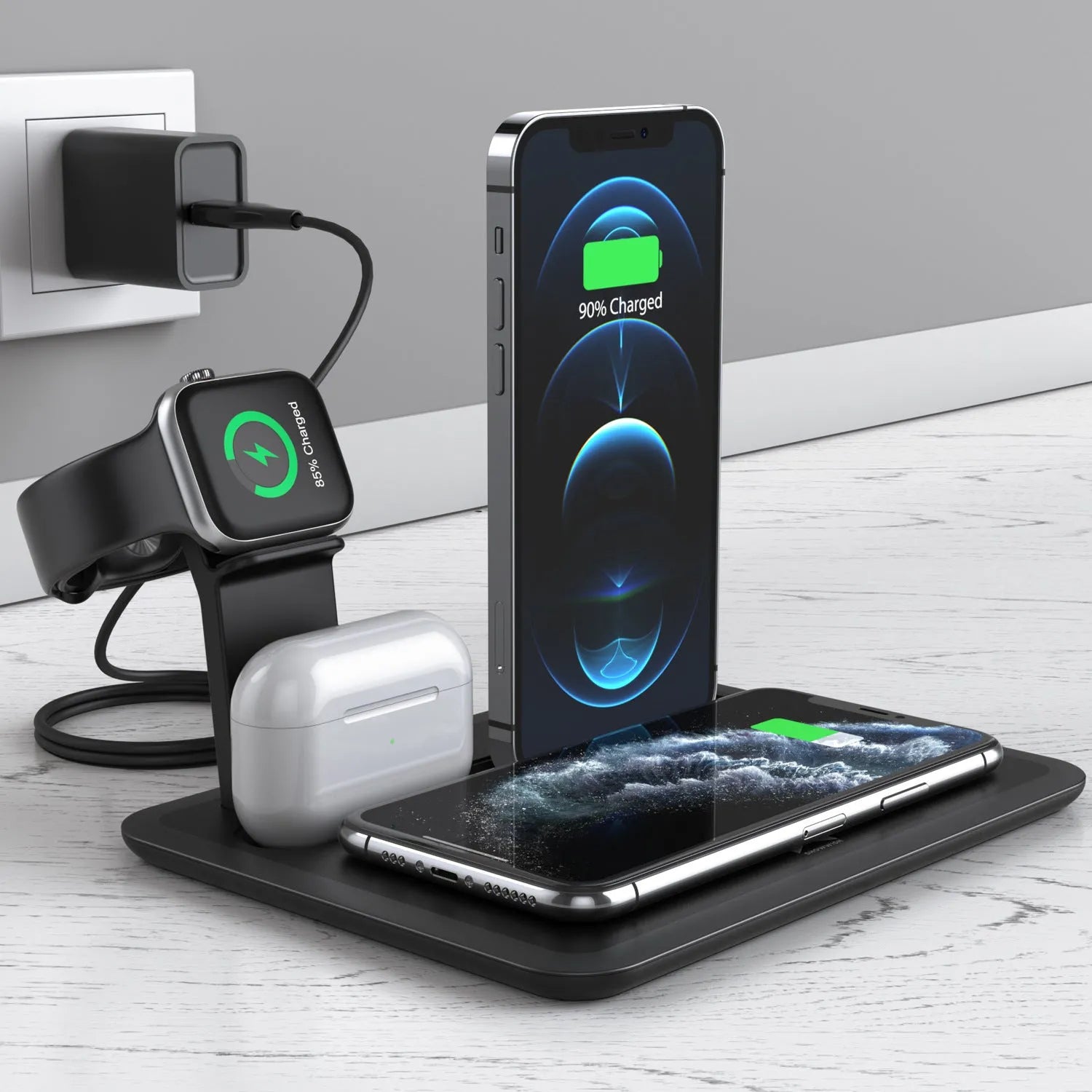 Black and white wireless charging station for phone, smartwatch, and headphones on a desk.