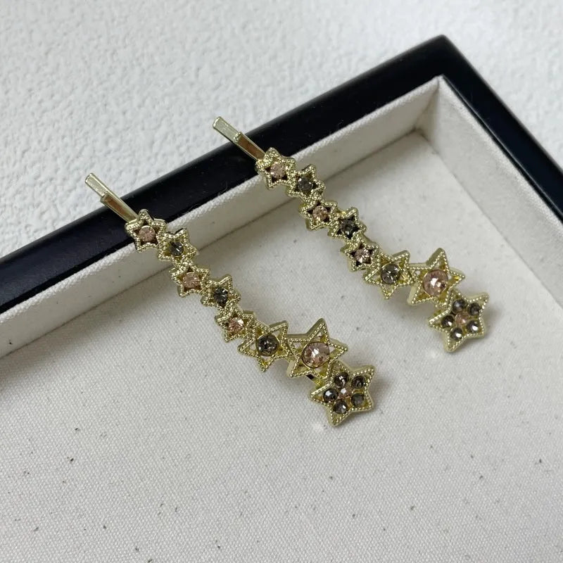 Gold hair barrette clip with rhinestone star detail on side