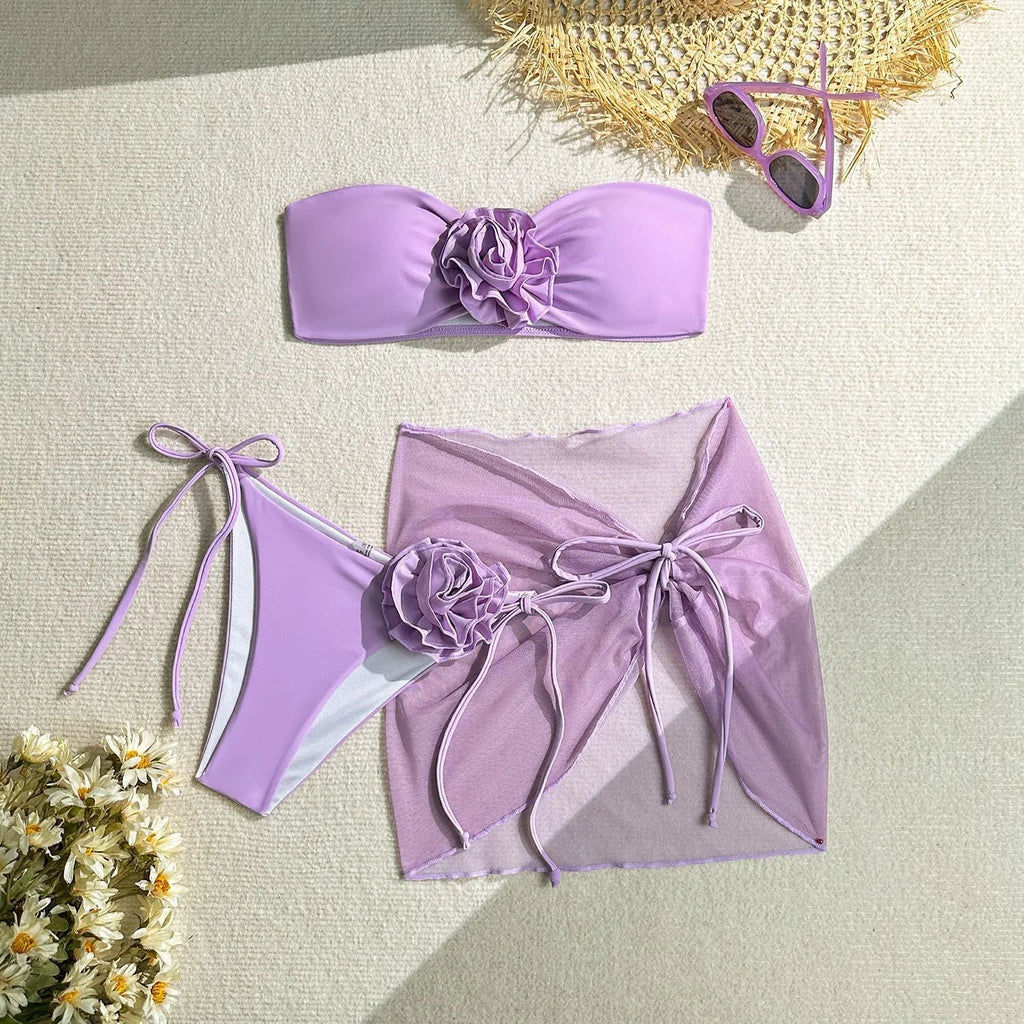 Women's pink tube top swimsuit with large 3D flower tie, matching pants and skirt.