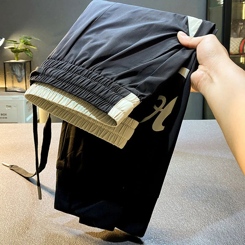 Black men's cropped trousers with elasticated ankle band in ultra-thin ice silk fabric