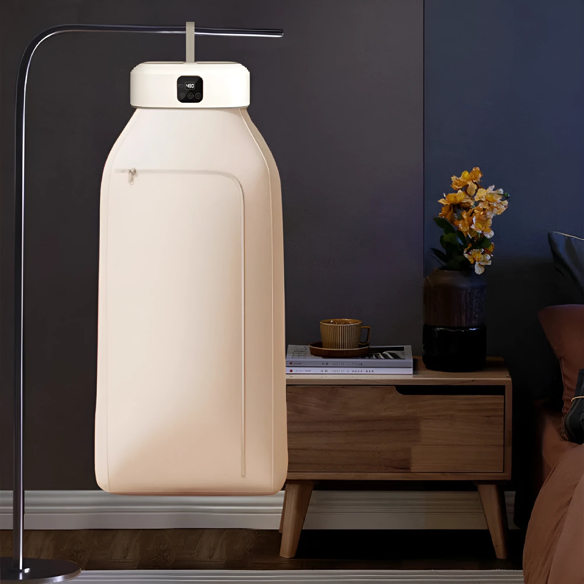White cylindrical laundry dryer with remote control on surface showing compact 29cm length design