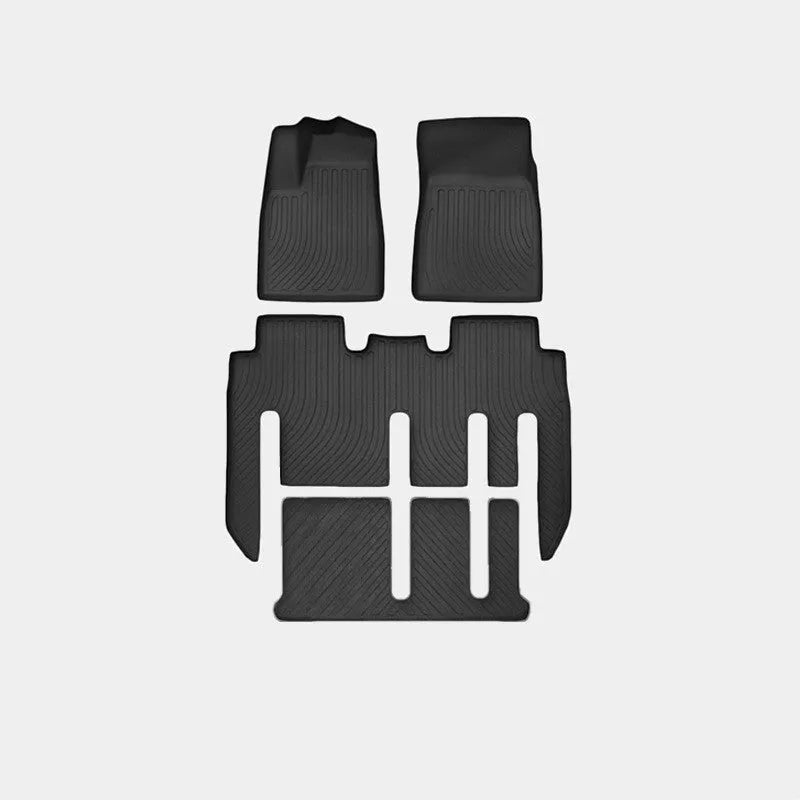 Tesla Model X black TPE rubber floor mats and boot liner set on car interior.