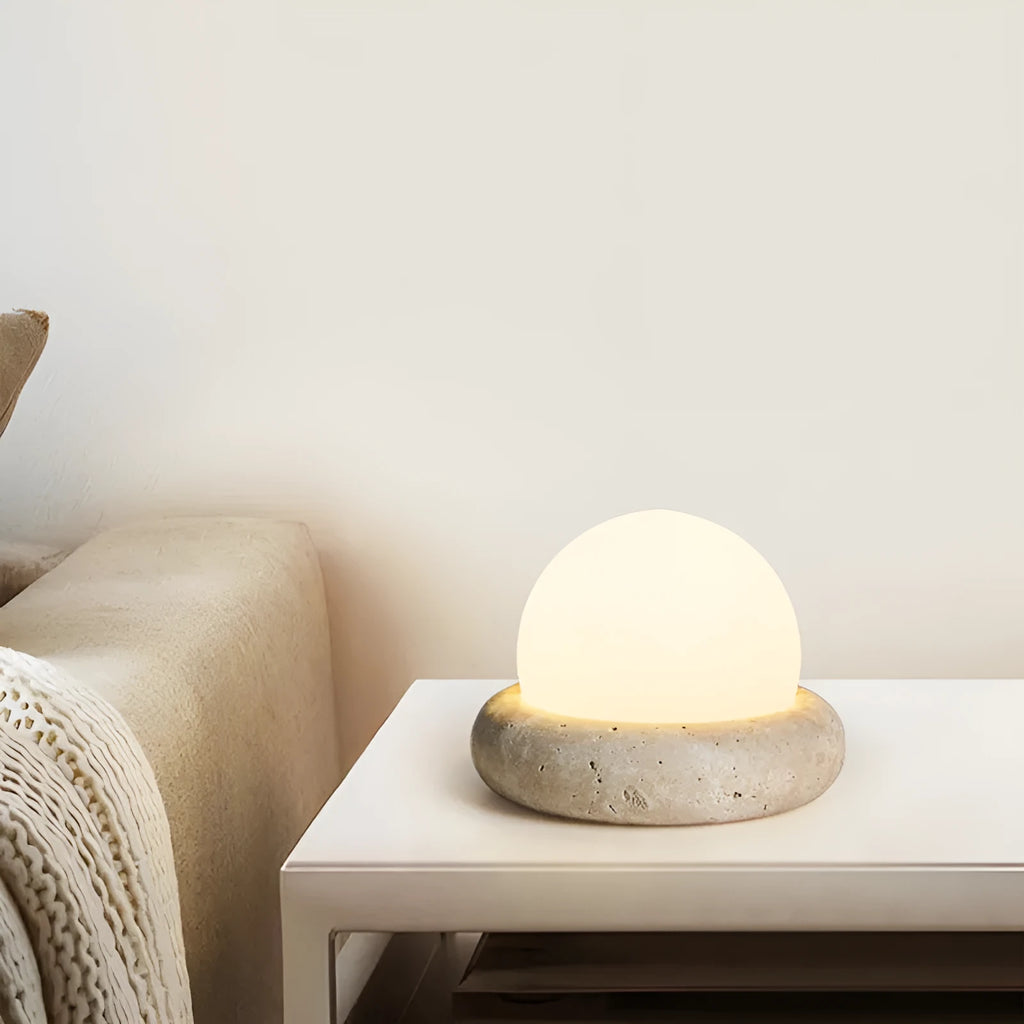 Cream colour bedside night lamp with remote control on wooden bedside table