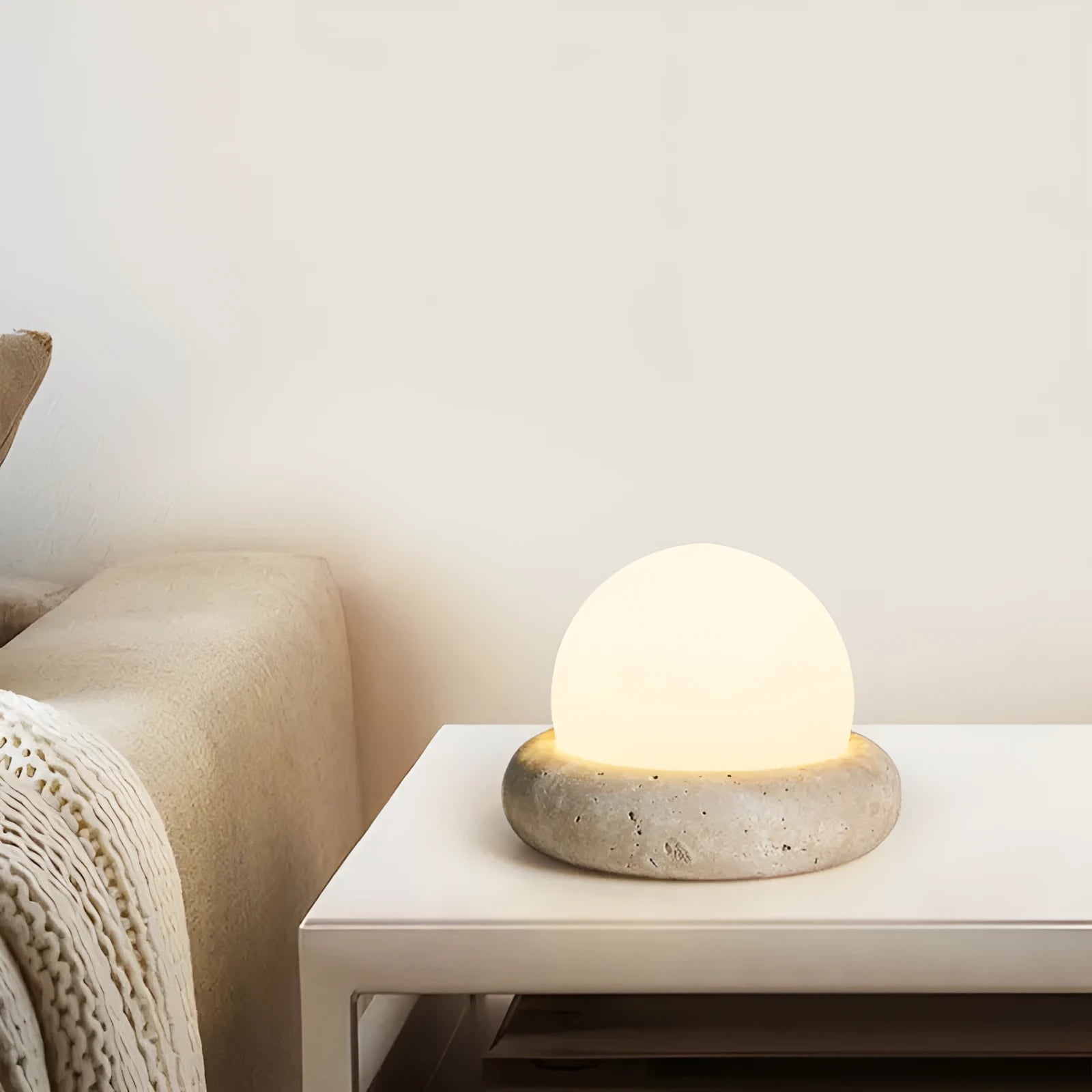Cream colour bedside night lamp with remote control on wooden bedside table