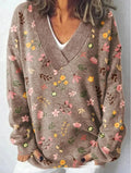 Women's white floral print V-neck sweatshirt with 3D pattern and long sleeves on a hanger.
