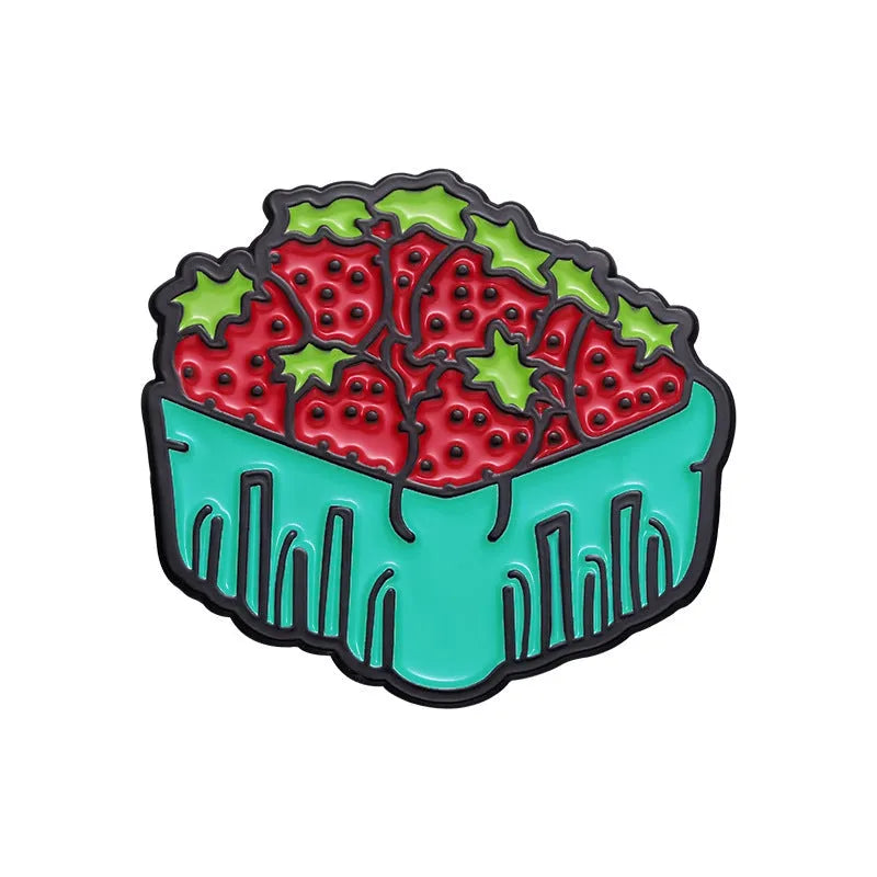 Colourful cartoon fruit design metal brooch pin on a fabric background.
