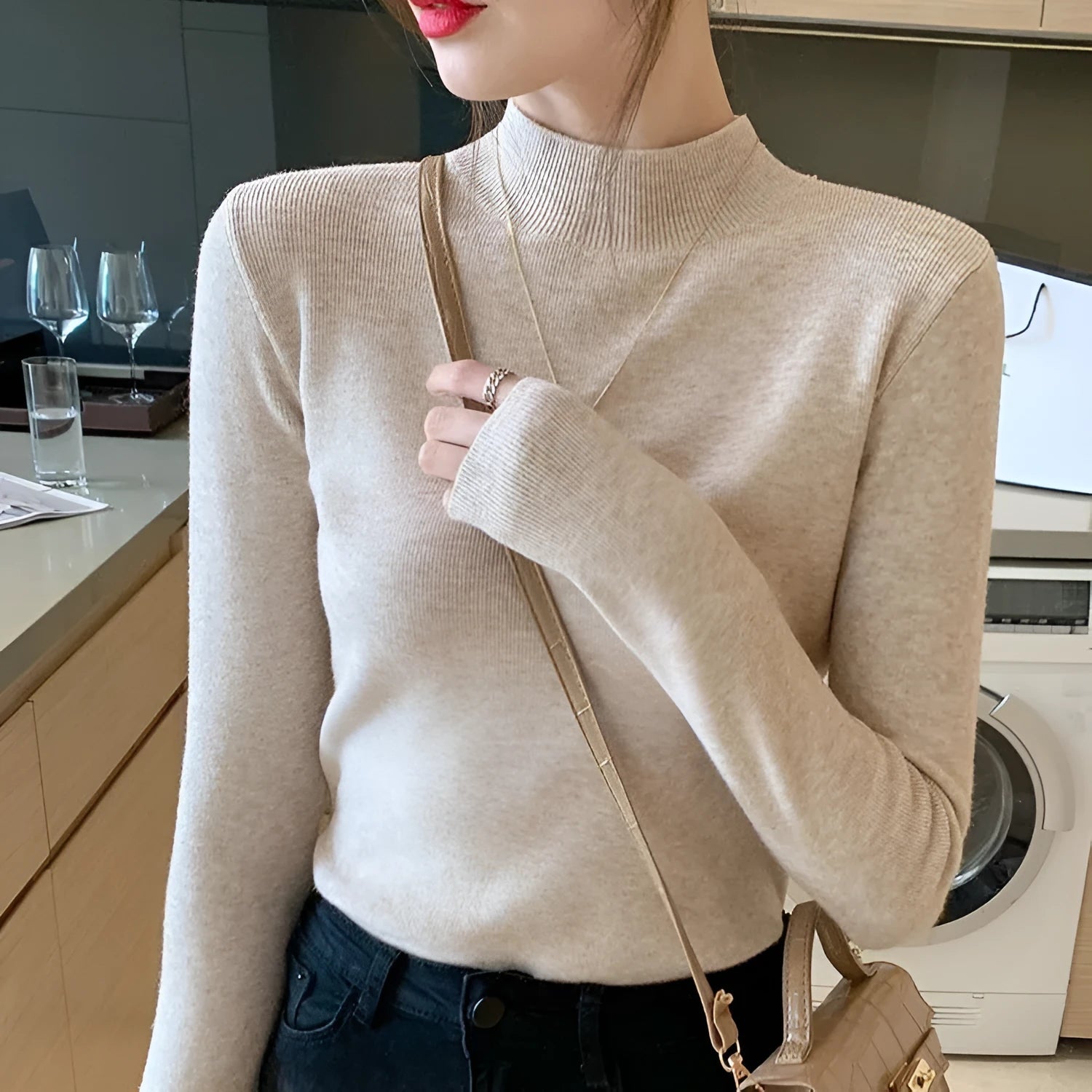 Women's slim fit long sleeve knitted pullover top in viscose fabric on a hanger.