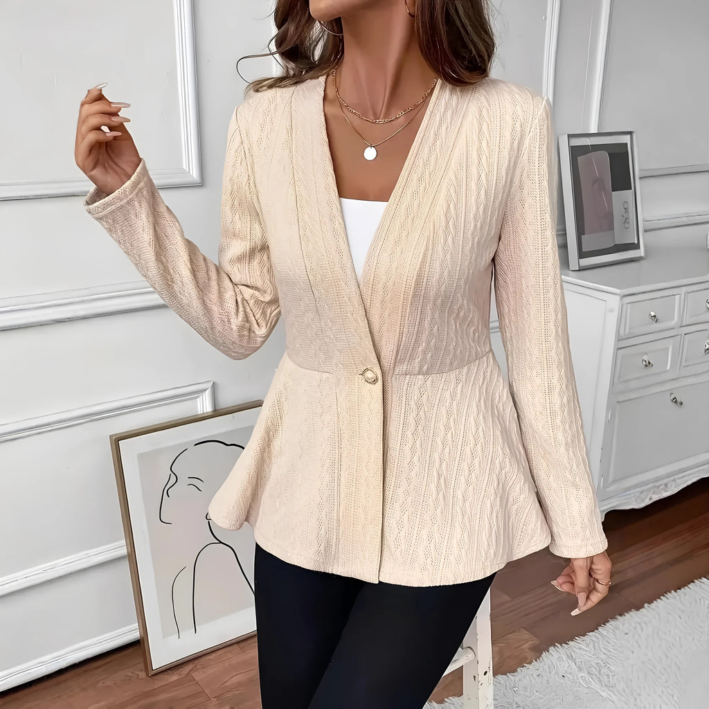Women's apricot coloured knitted cardigan with jacquard pattern and one button, shown on a model.