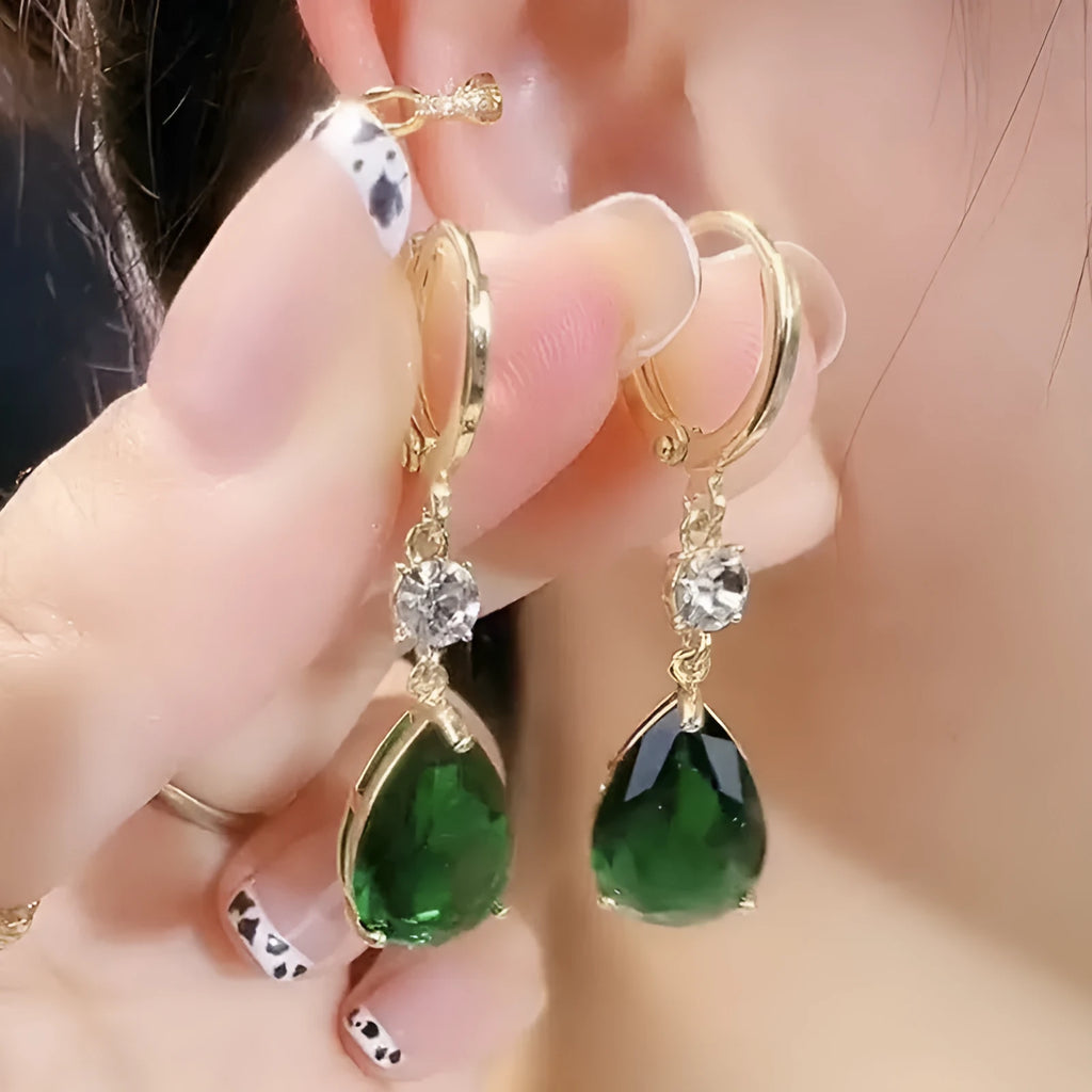 A pair of green geometric teardrop-shaped alloy earrings on a white background.