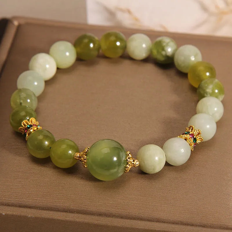 Women's bangle bracelet made from green Xiuyan jade stone with an original design.