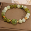 Women's bangle bracelet made from green Xiuyan jade stone with an original design.