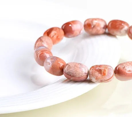 Natural cherry agate bracelet with barrel-shaped beads and ruyi design elements
