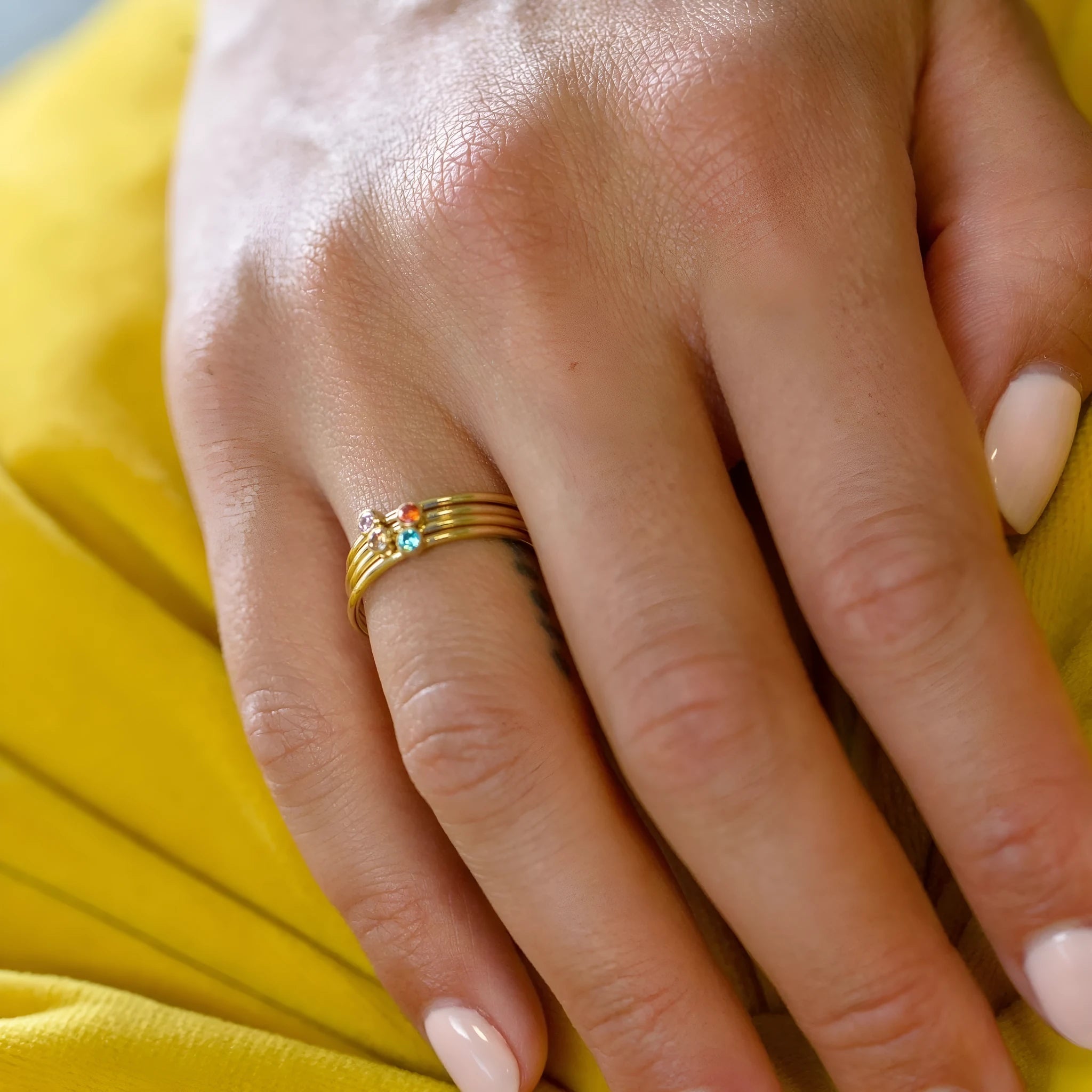 Geometric December birthstone engraved ring in titanium steel on a plain background.