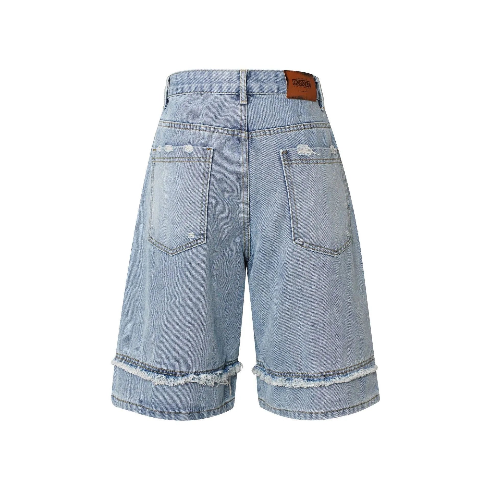 Distressed blue denim shorts with raw edge hem on a plain background, showing straight leg cropped fit.