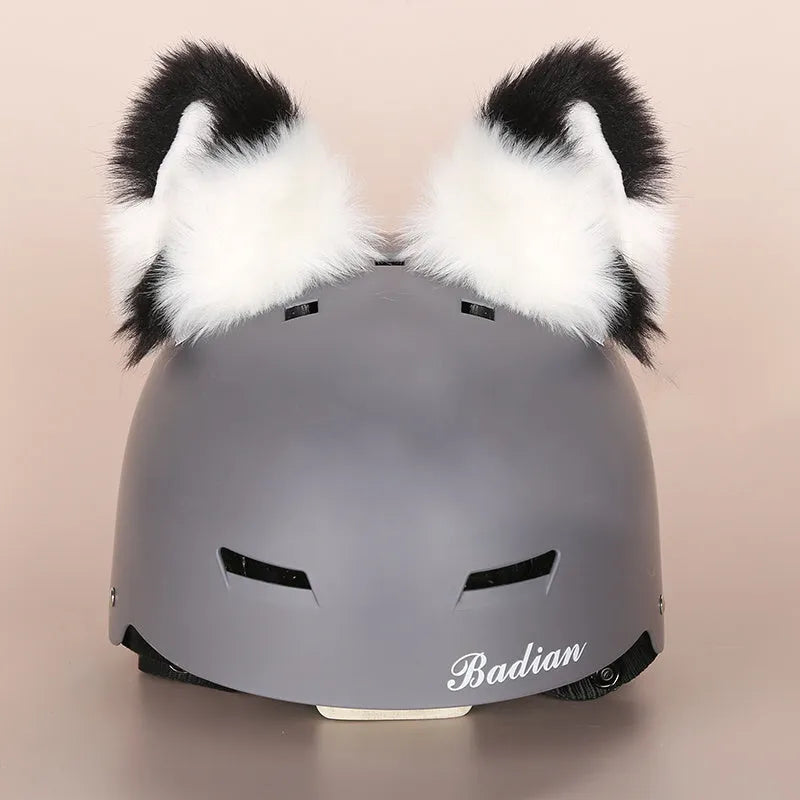 Plush fabric ski helmet decoration with cartoon design on a black ski helmet.