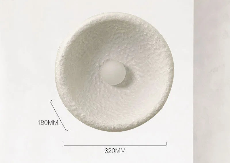 Japanese-style minimalist wall lamp with resin shade in three diameter options on modern interior wall