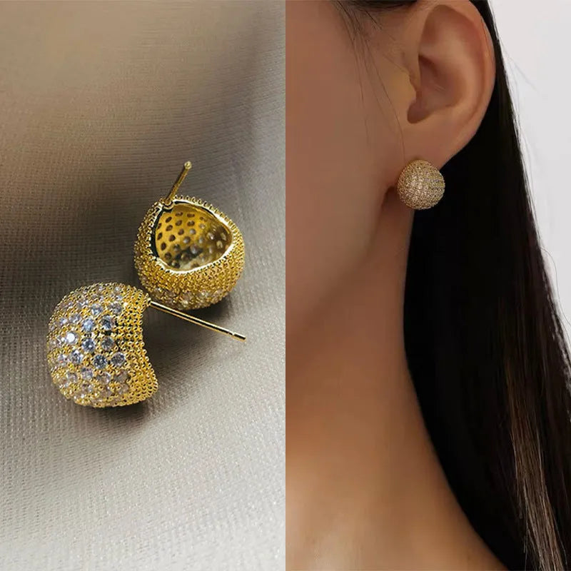 Geometric drop-shaped ear clips with full diamond detailing and sphere elements in gold and white colour options