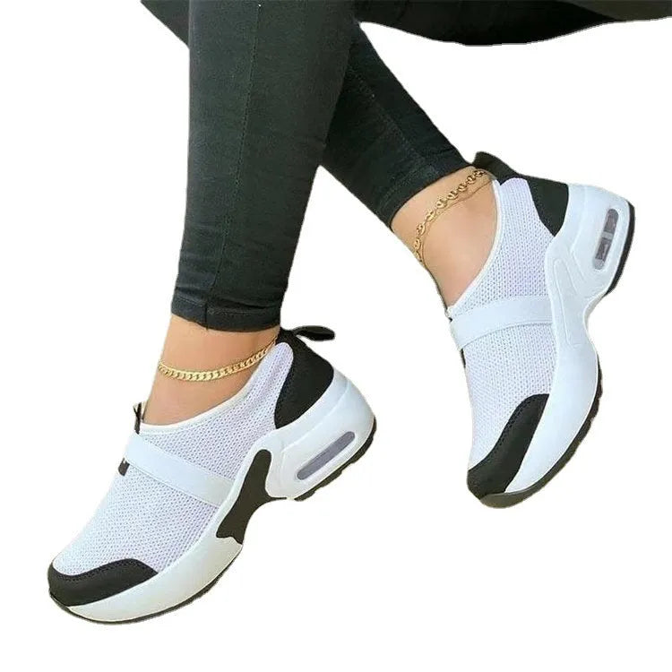 Women's flat mesh sneakers in light grey with white rubber soles and colour stitching.