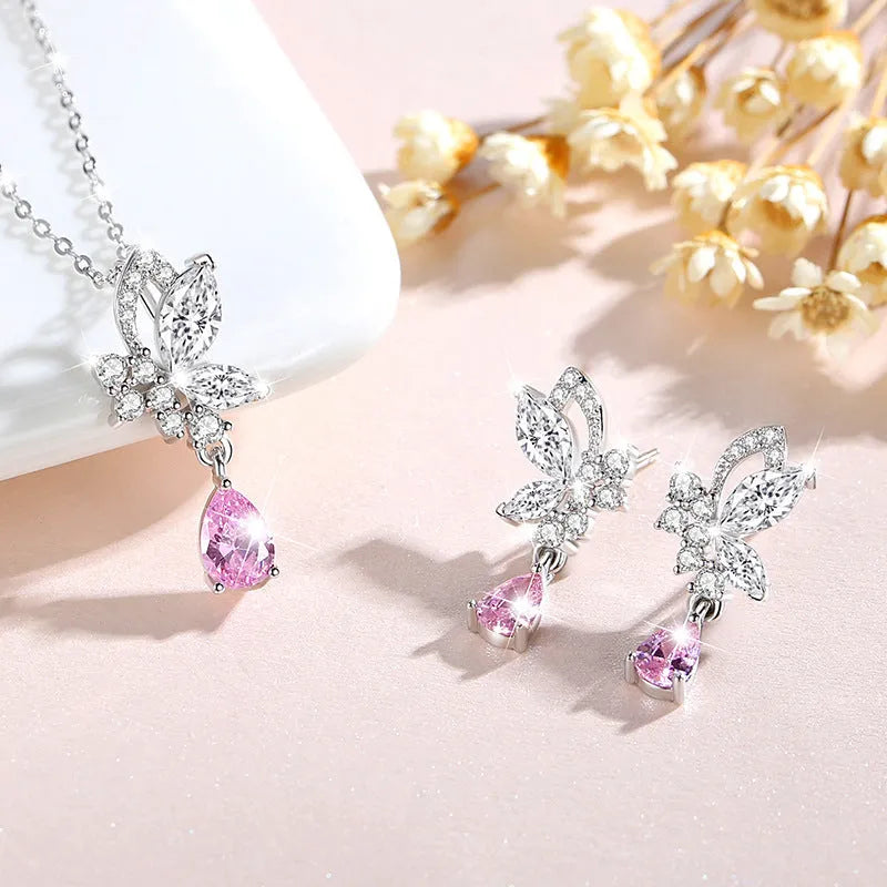 A pair of sterling silver butterfly stud earrings with crystal details on a white background.