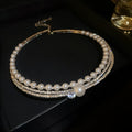 Silver curved geometric necklace emphasising collarbone with clavicle chain styling