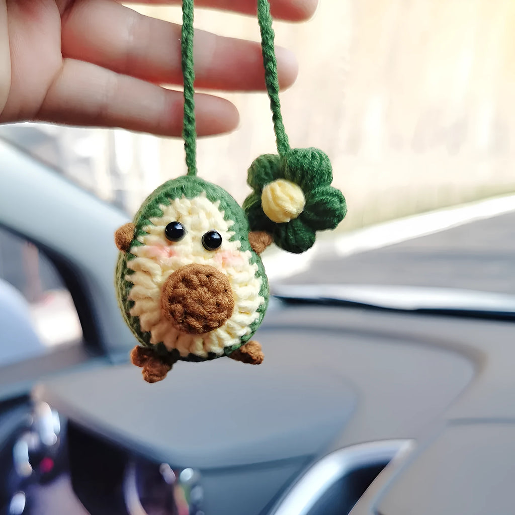 Handmade crocheted wool car pendant in avocado, pink rainbow, or red rainbow colours with cartoon styling