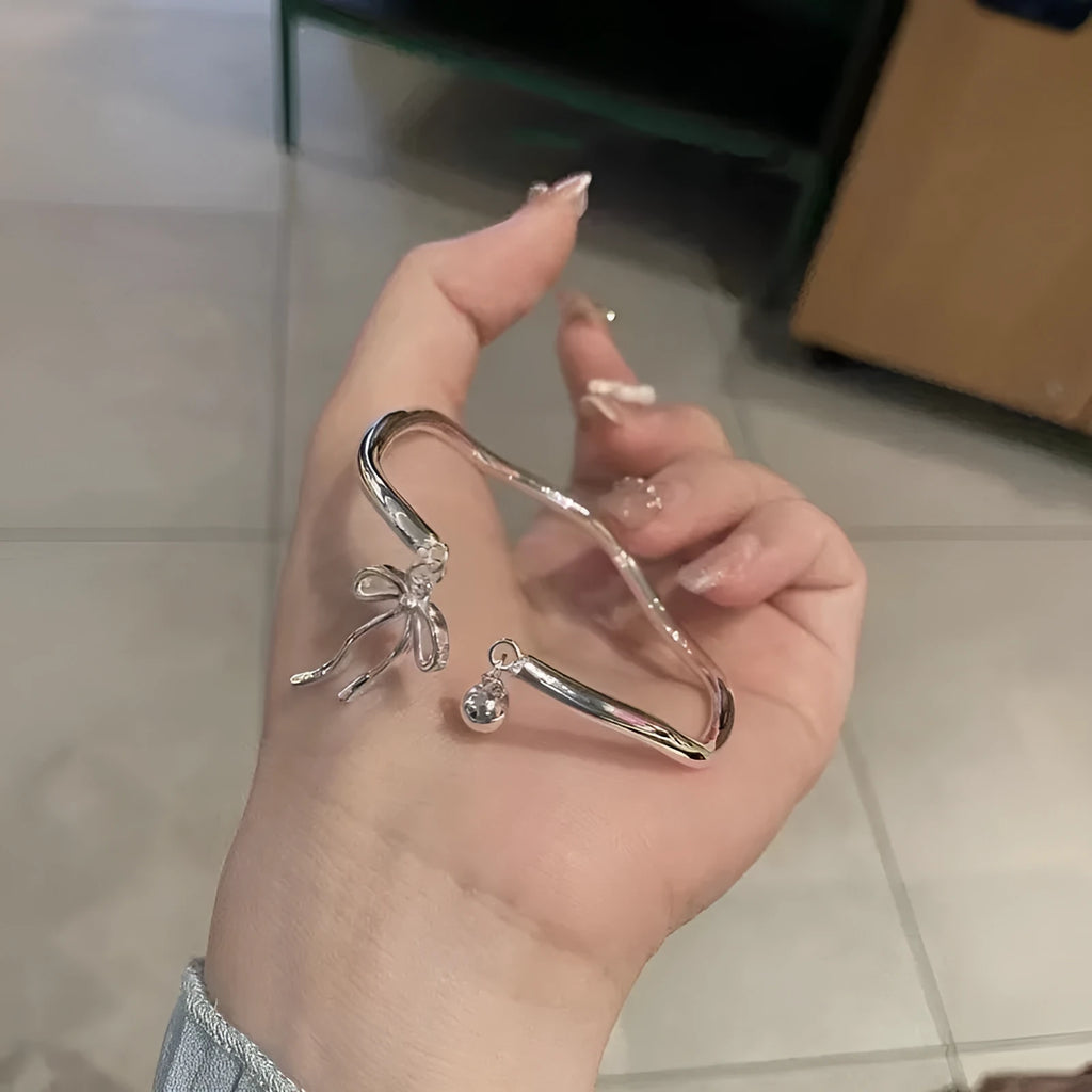 Silver bow girlfriends bracelet with adjustable bell opening clasp on zinc alloy