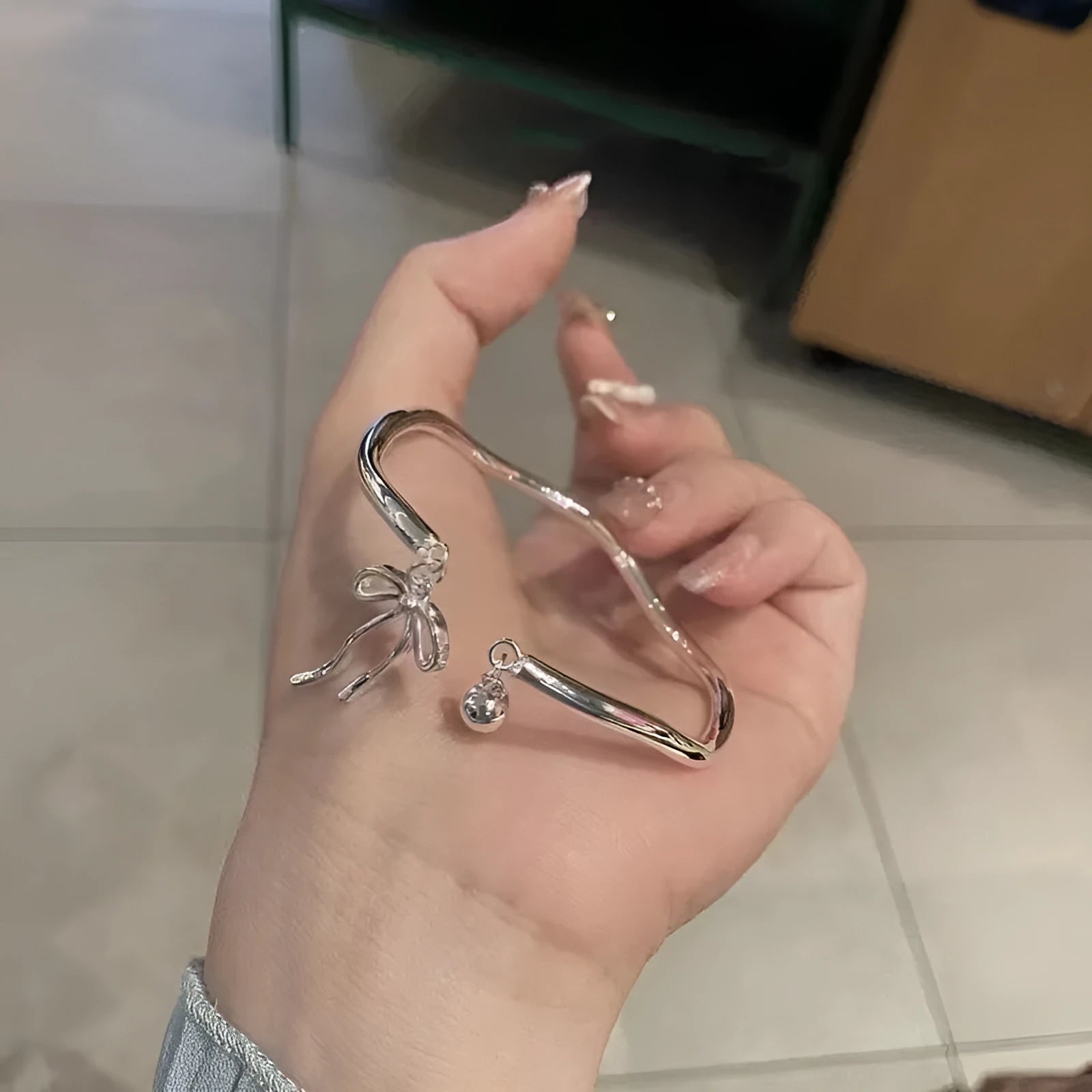 Silver bow girlfriends bracelet with adjustable bell opening clasp on zinc alloy