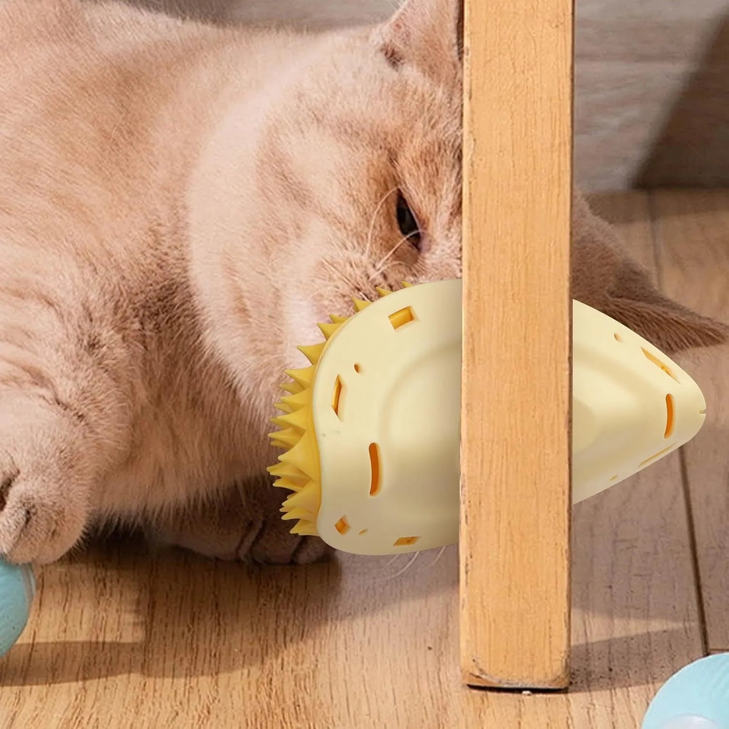 Yellow durian-shaped cat corner scratcher with textured surface and packet of cat mint powder