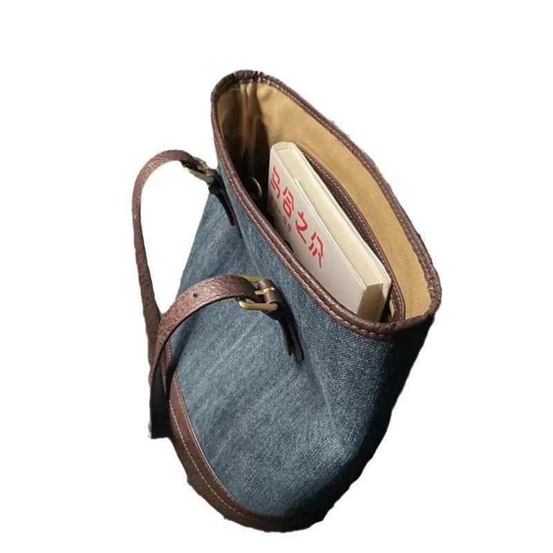 Large denim patchwork bucket handbag showing adjustable strap and retro styling