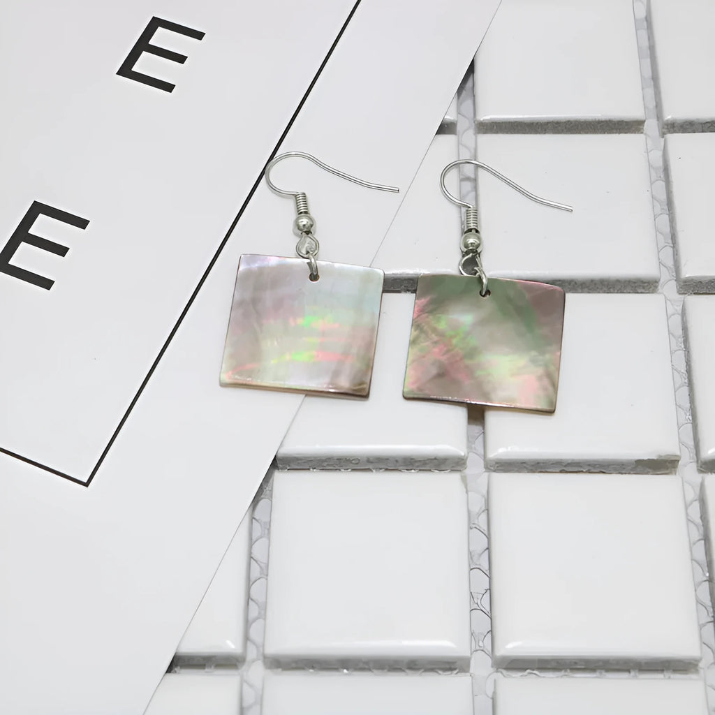 A pair of geometric-shaped women's earrings made from natural shell in a retro style.