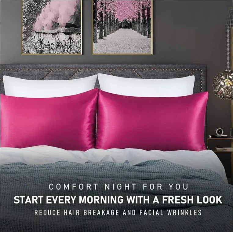 Pair of solid colour satin pillowcases in polyester fabric on a bed.