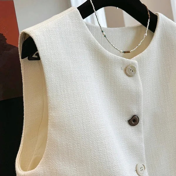 Women's milky white French-style bandage vest with round neck and sleeveless design on a hanger.