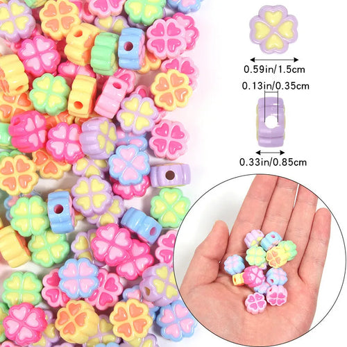 A pile of 15mm frosted acrylic four-leaf clover beads in mixed colours including pink, green, and blue.