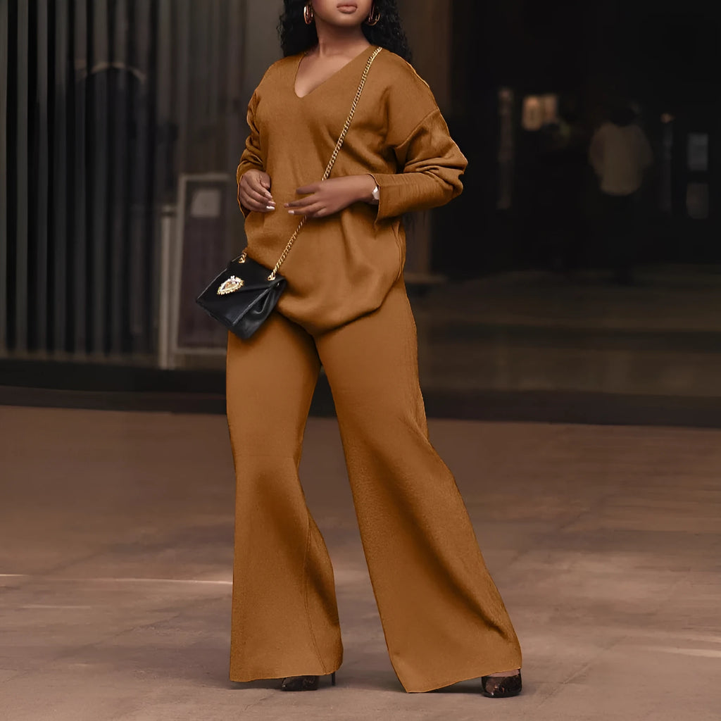 Women's brown suede two-piece suit with split sleeve detail on the long-sleeved top and matching trousers.
