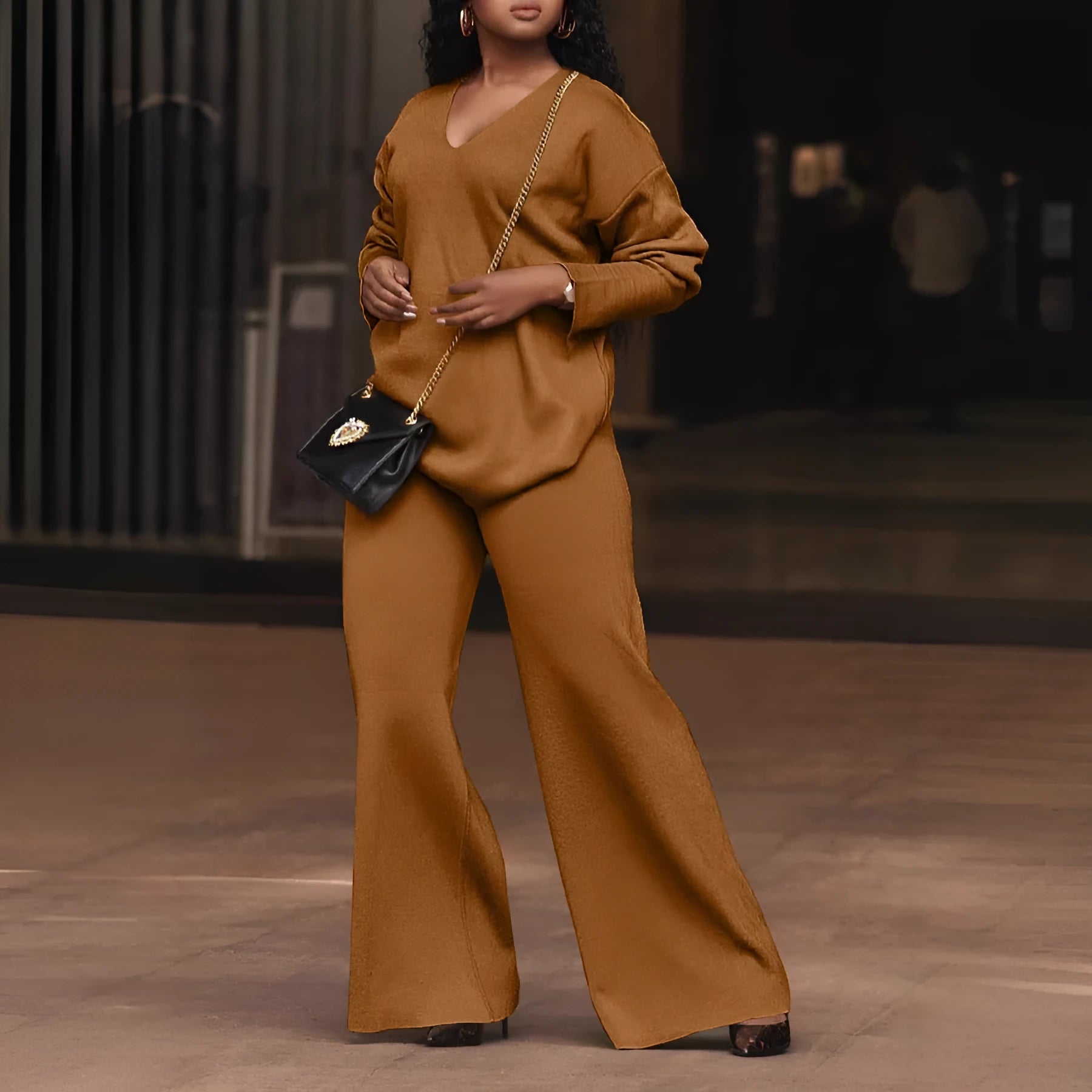 Women's brown suede two-piece suit with split sleeve detail on the long-sleeved top and matching trousers.