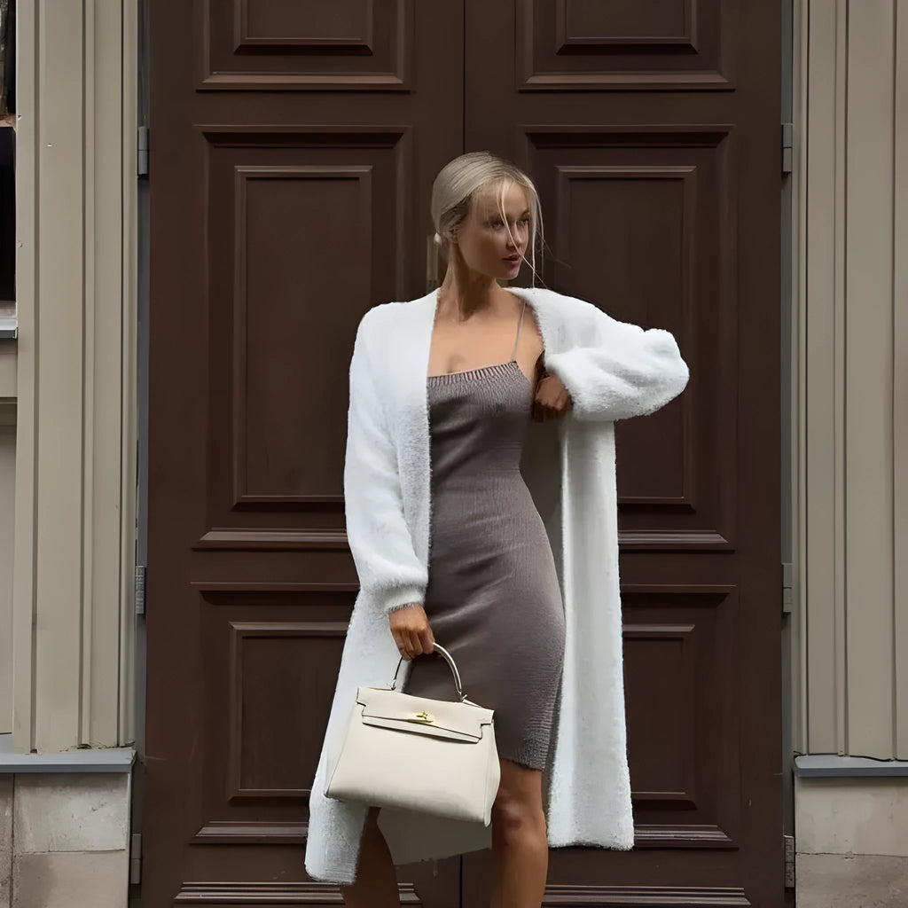 White longline women's cardigan jacket with long sleeves made from thick polyester knit fabric.