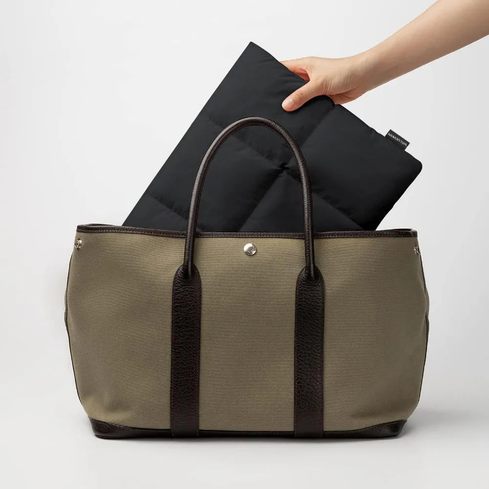 Black and khaki polyester laptop sleeve with sewing thread detail for 13 to 15.6 inch laptops.