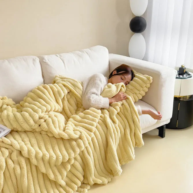 Soft Wind double-sided thickening bubble velvet blanket in a solid colour shown on a sofa.