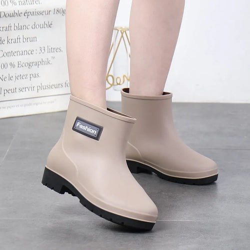 Women's black PVC rain boots with mid-calf height and low heel