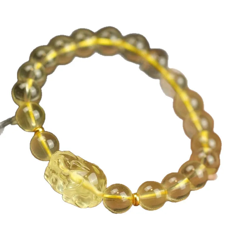 Yellow leather cord bracelet with an artificial citrine crystal Pi Xiu charm and beads.
