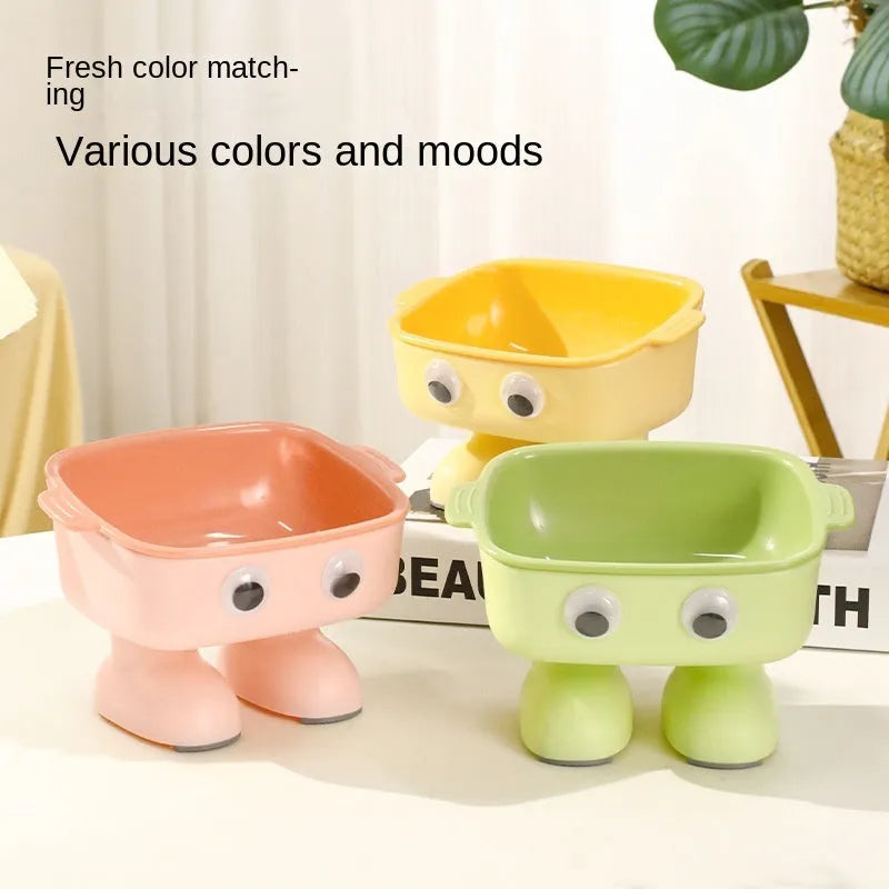 Green robot-shaped elevated cat bowl with tilted design and detachable inner component