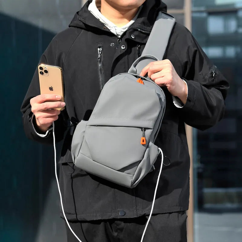 Men's black casual crossbody bag made from waterproof polyester with an adjustable shoulder strap.