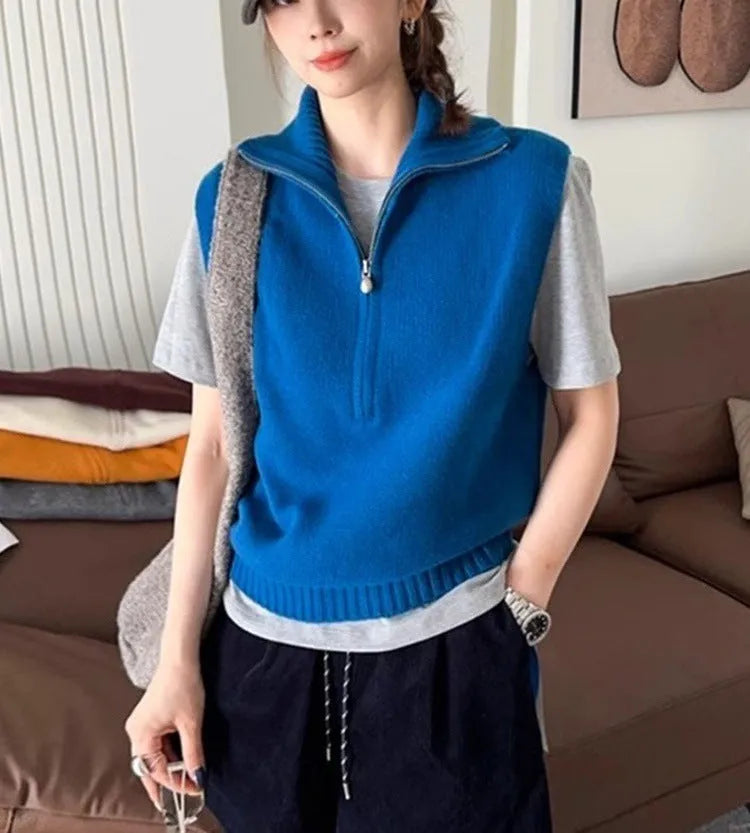 Retro half-zip sleeveless knit vest in solid colour polyester mesh fabric on a hanger.